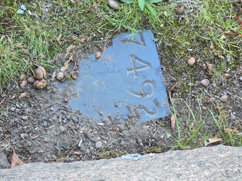Lot 7492 marker at the base of the monument